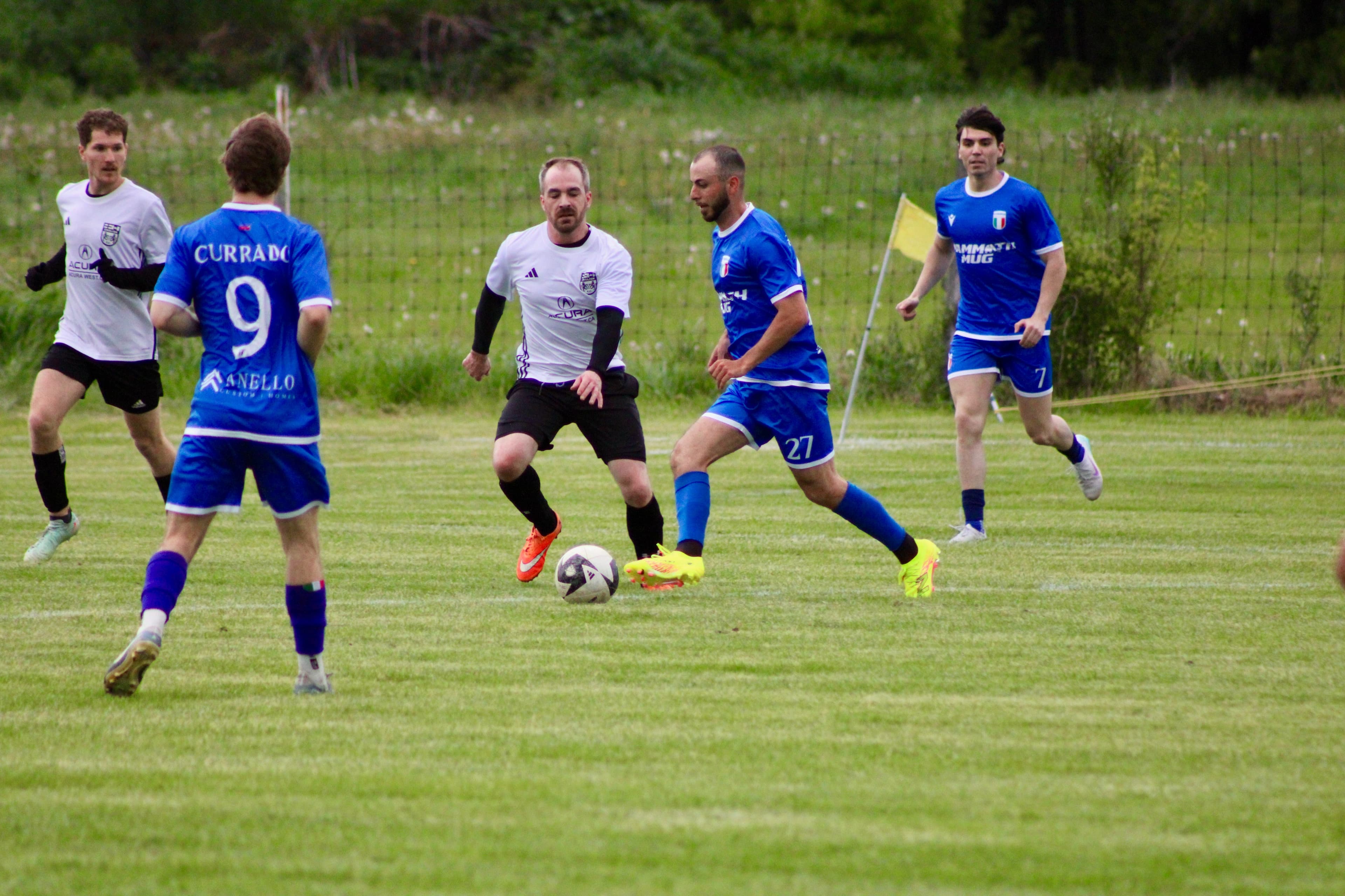Soccer players competing for ball control in midfield