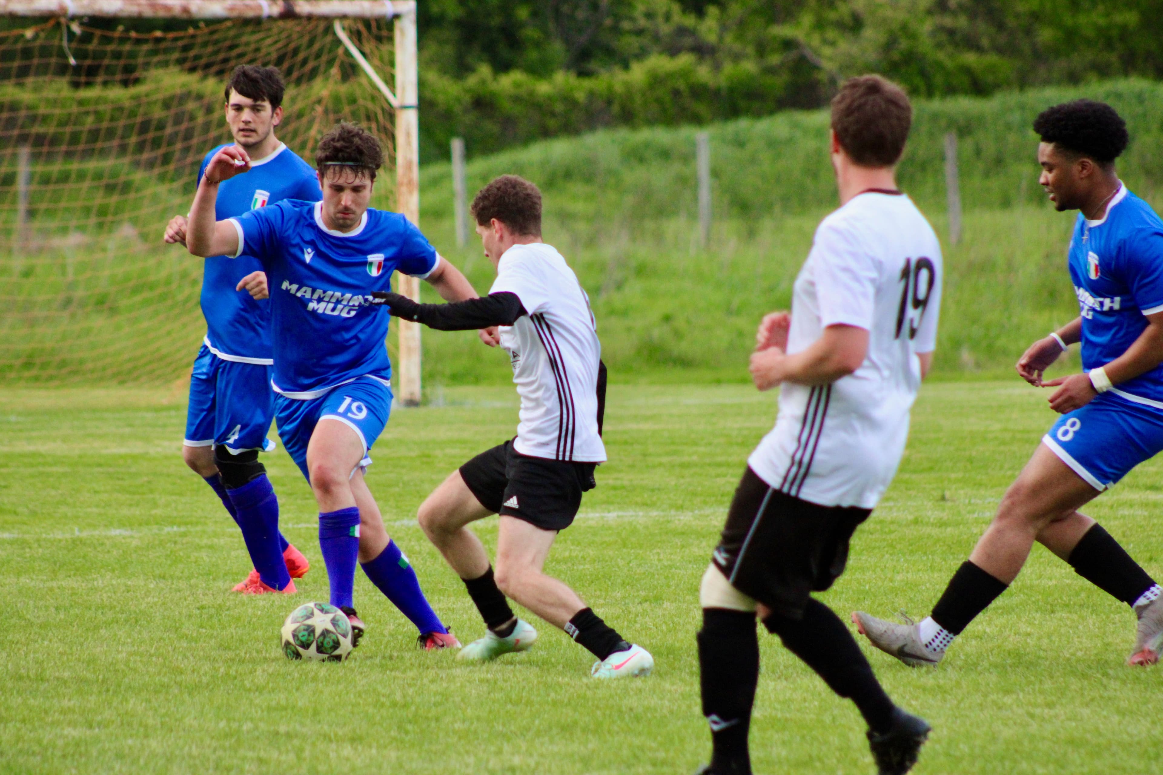 Players battling for ball control near the goal