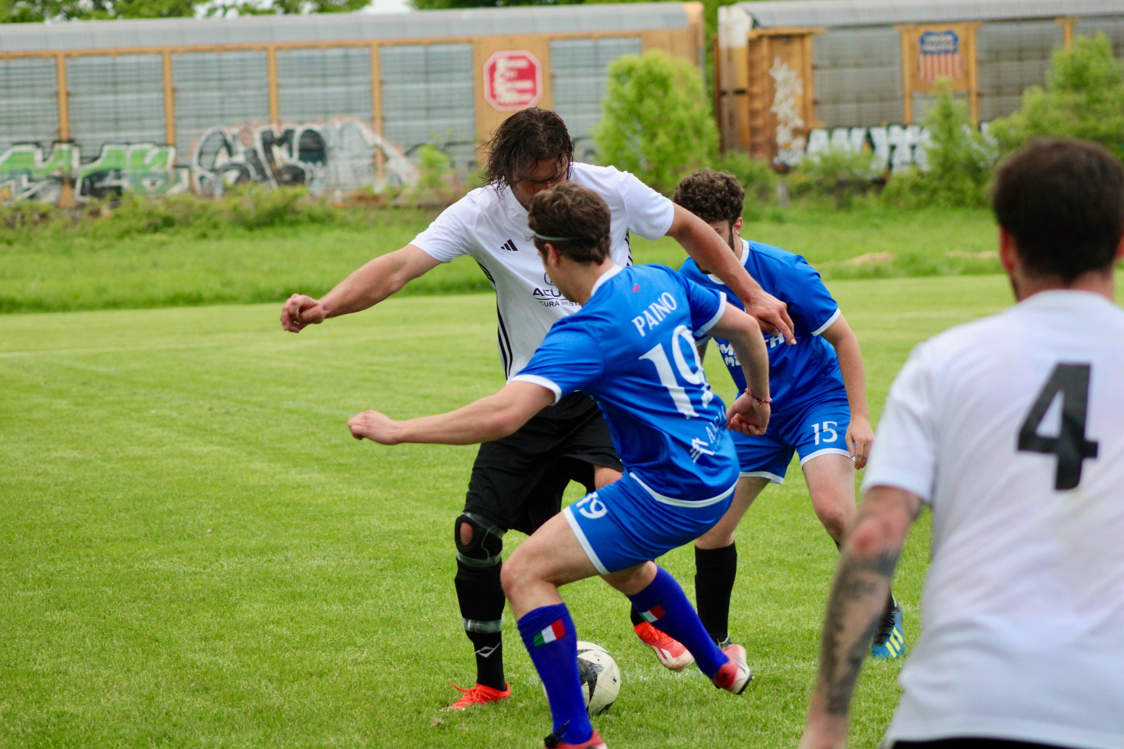 Multiple players converging on the ball